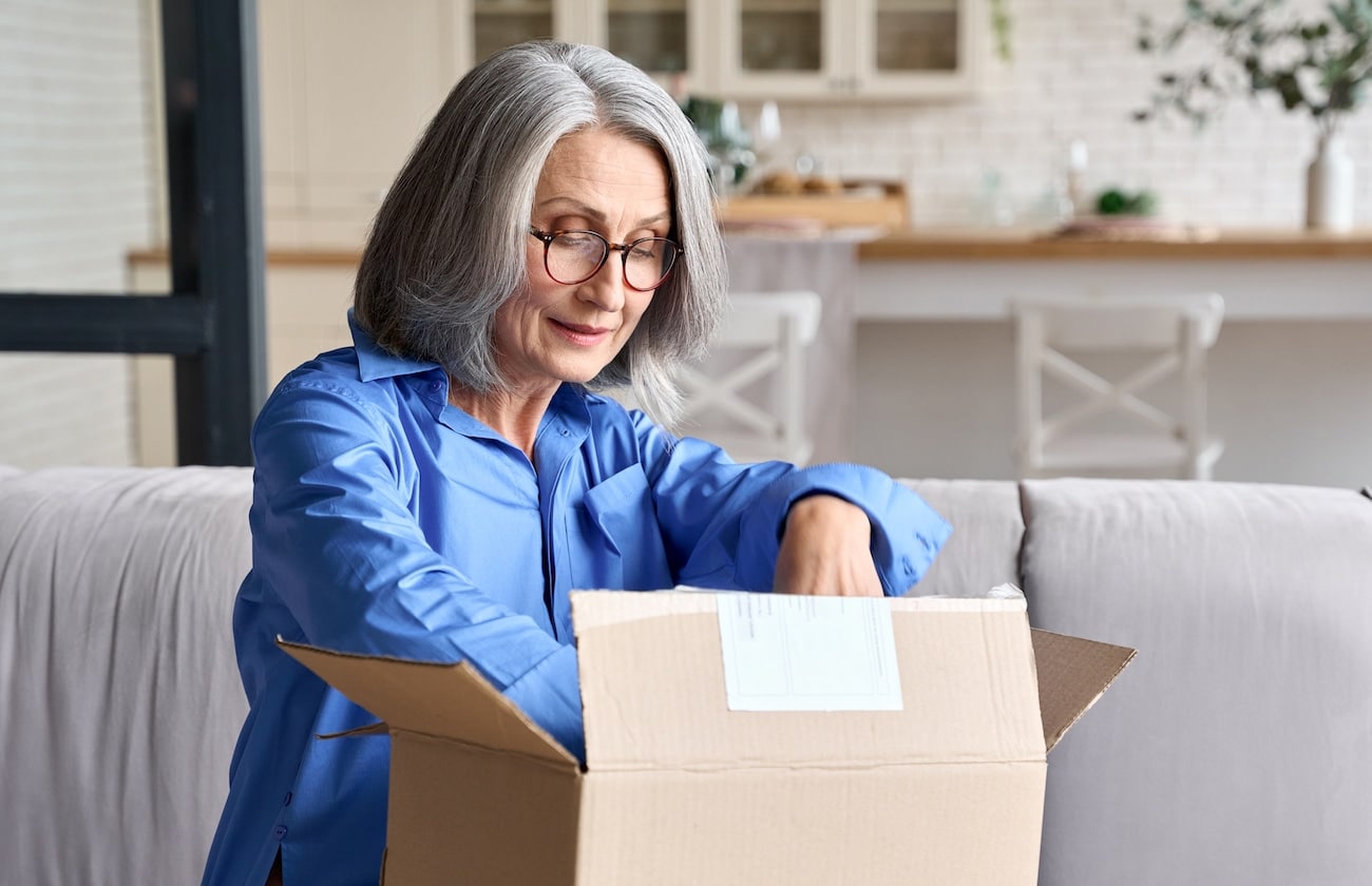 Happy,Senior,Middle,60s,Aged,Woman,Opening,Box,With,Ordered