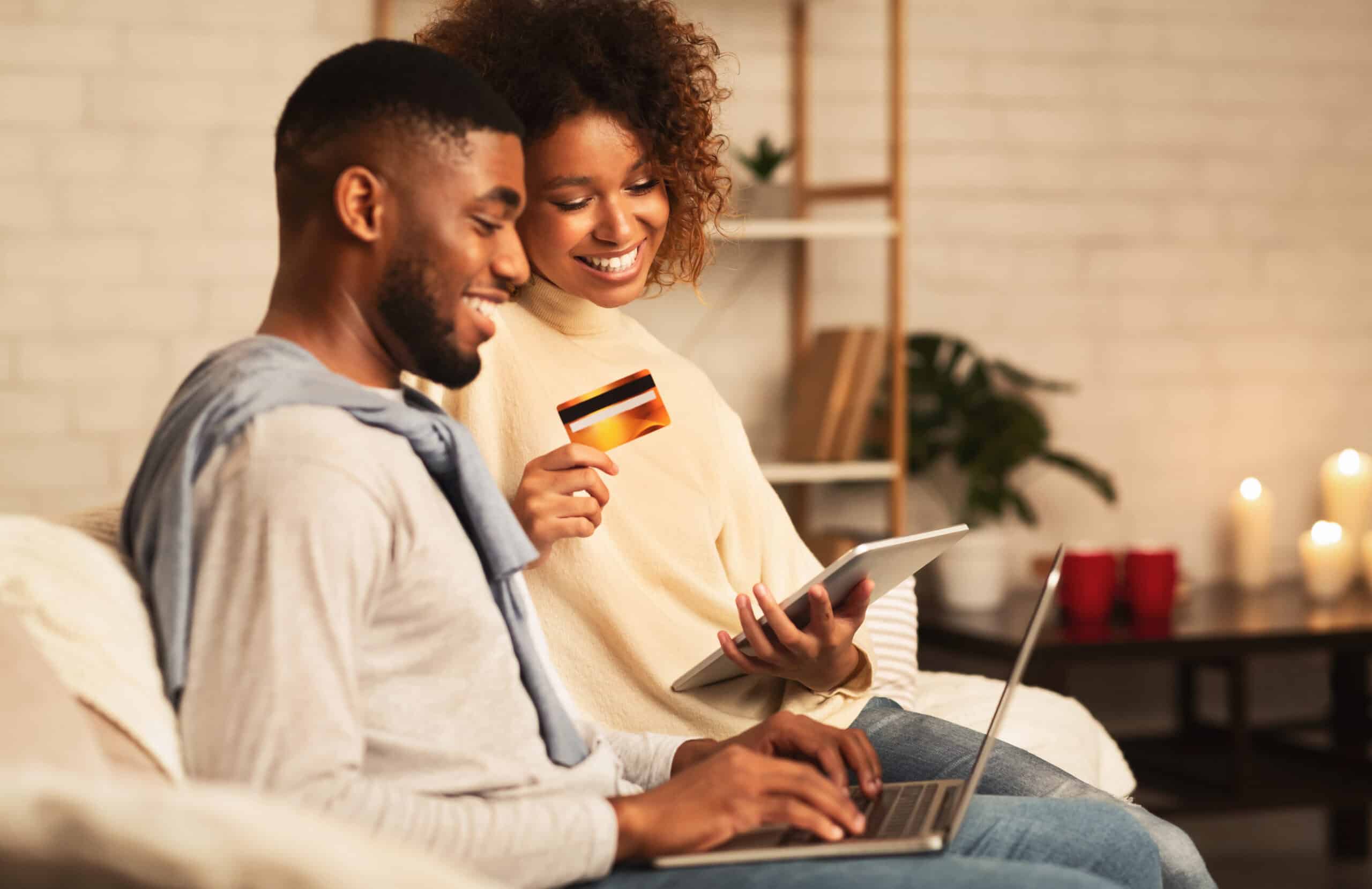 E-commerce,Concept.,African-american,Couple,Using,Laptop,And,Credit,Card,,Buying