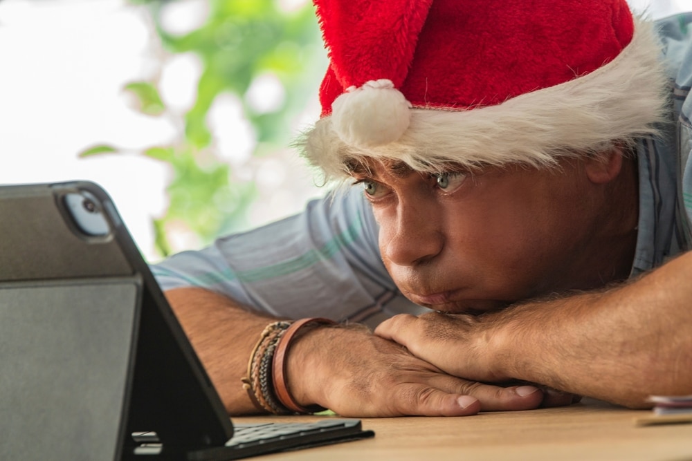 Man,With,Santa,Hat,Bored,And,Stressed,In,The,Office