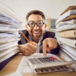 Funny,Smiling,Happy,Business,Man,In,Suit,And,Glasses,Working