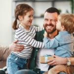 Happy father getting congratulations from kids