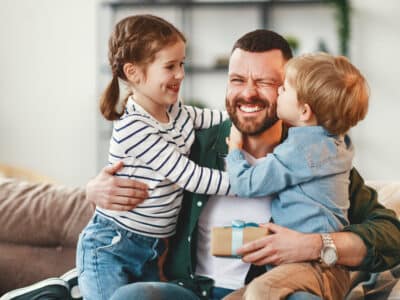 Happy father getting congratulations from kids