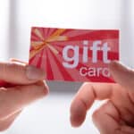 Close-up,Of,Female,Hand,Giving,Gift,Card,To,Her,Male