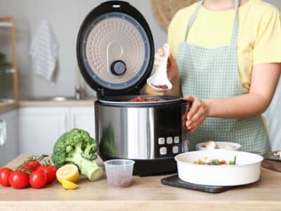 Woman,Preparing,Rice,In,Multi,Cooker,At,Kitchen,Table